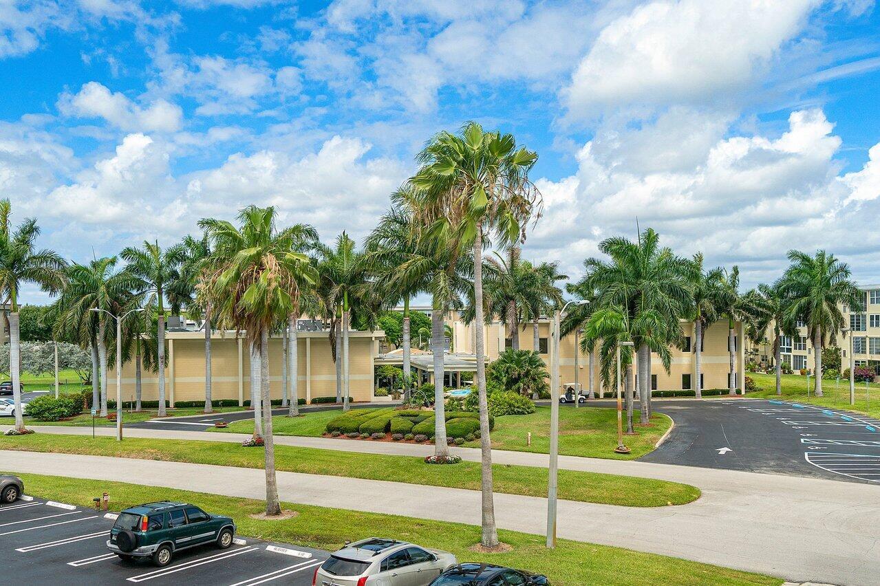 2615 Northeast 1st Court, Unit 301 Boynton Beach, FL 33435 - Photo 31 of 40 a view of a swimming pool with a lawn chairs