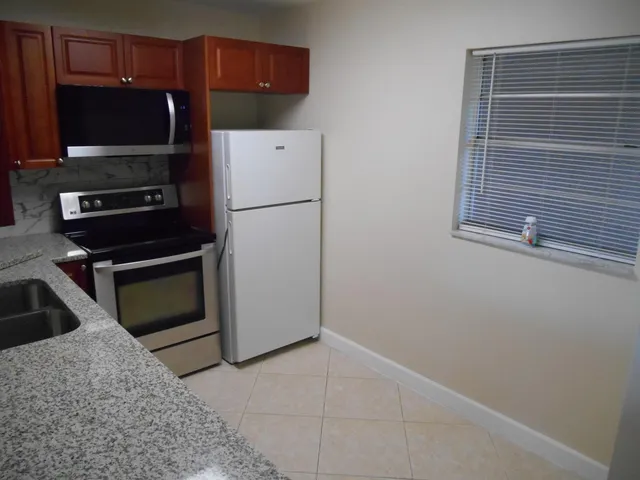 a kitchen with a refrigerator and a sink