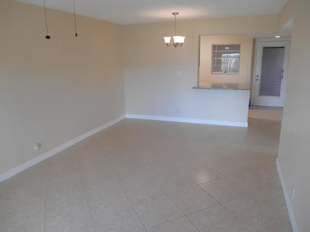 en empty room with windows and ceiling fan