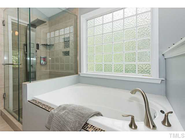 1205 Red Brick Road Garner, NC 27529 - Photo 12 of 19 a bathroom with a bathtub and a shower