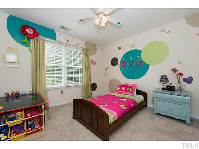1205 Red Brick Road Garner, NC 27529 - Photo 13 of 19 a bedroom with a bed window and dresser