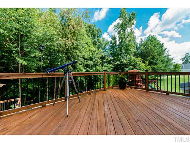1205 Red Brick Road Garner, NC 27529 - Photo 18 of 19 a view of backyard with a large tree and wooden fence