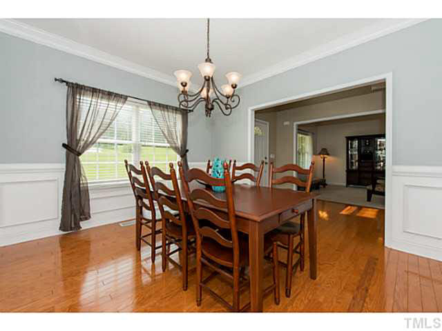 1205 Red Brick Road Garner, NC 27529 - Photo 3 of 19 a view of a dining room with furniture and a chandelier