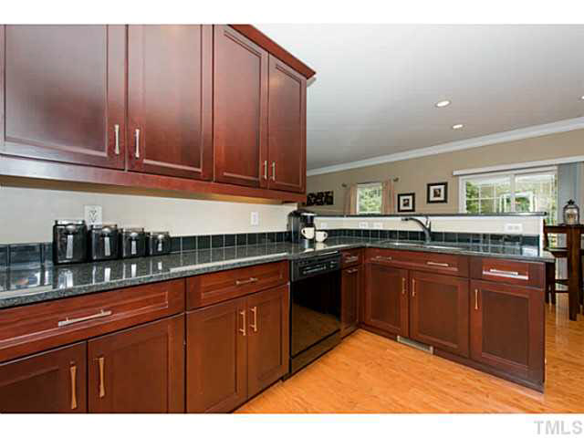1205 Red Brick Road Garner, NC 27529 - Photo 4 of 19 a kitchen with stainless steel appliances granite countertop wooden cabinets and a counter top space