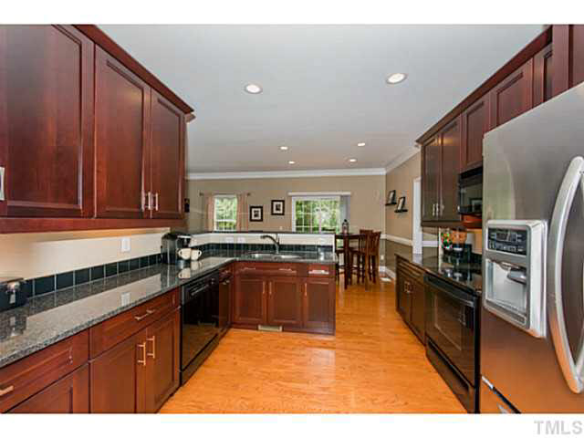 1205 Red Brick Road Garner, NC 27529 - Photo 5 of 19 a kitchen with stainless steel appliances granite countertop sink stove top oven and cabinets