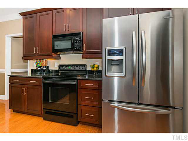 1205 Red Brick Road Garner, NC 27529 - Photo 6 of 19 a kitchen with stainless steel appliances and granite countertop