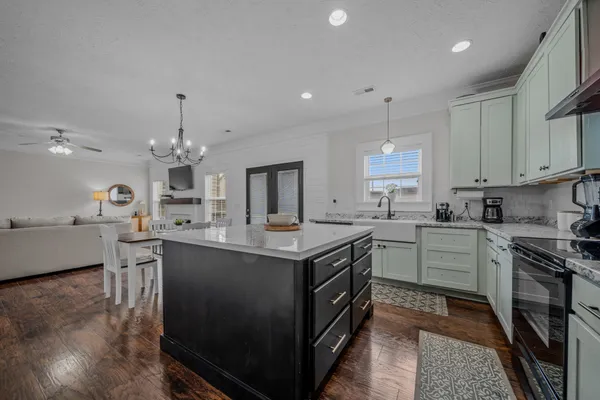 a kitchen with a stove sink and cabinets
