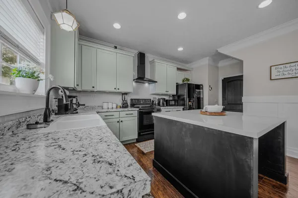 a kitchen with stainless steel appliances granite countertop a sink stove and refrigerator