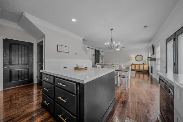a view of kitchen center island wooden floor and living room