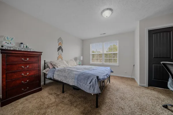 a bed room with a bed and a television