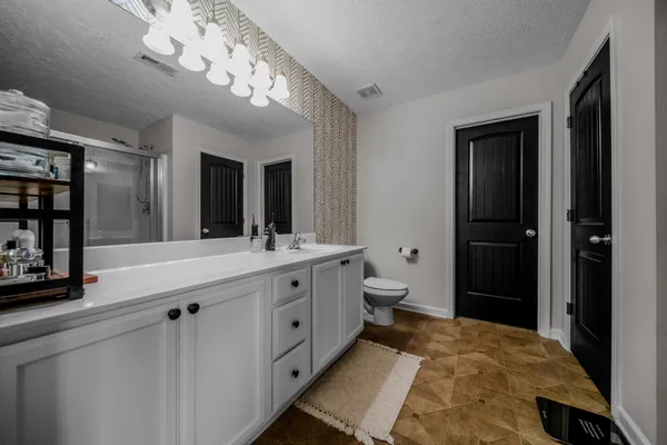 a bathroom with a double vanity sink and a mirror