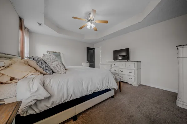 a bedroom with a bed and a tv