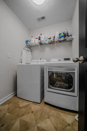 a utility room with sink dryer and washer
