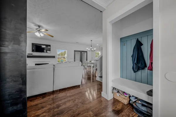 a view of a hallway with workspace and wooden floor