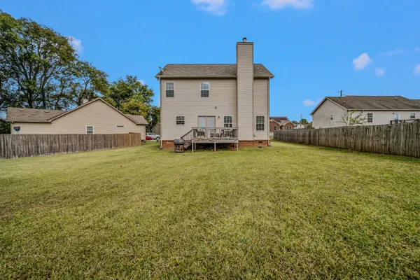 a view of a house with a backyard