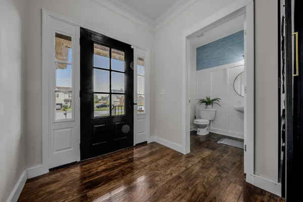 a view of a bedroom with wooden floor and a bathroom