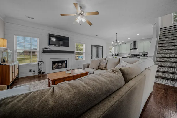 a living room with furniture fireplace and flat screen tv
