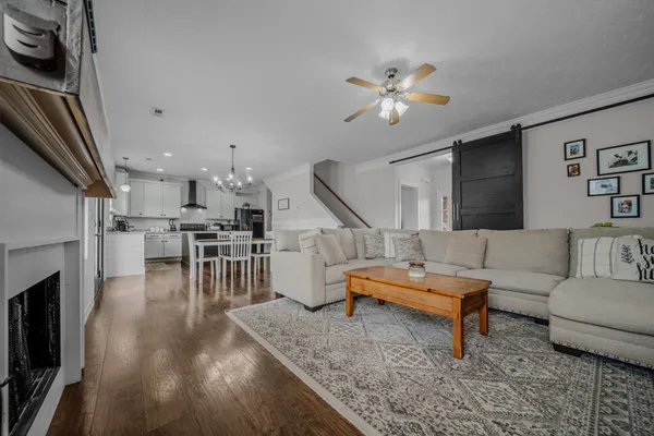 a living room with furniture and kitchen view