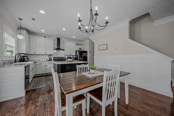 a view of a dining room with furniture and wooden floor