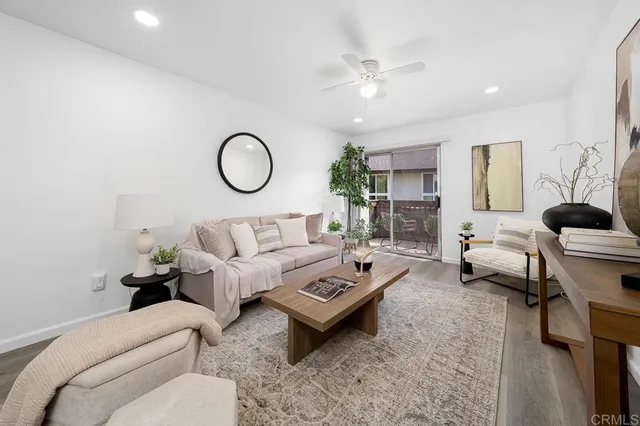 a living room with furniture a rug and a chandelier