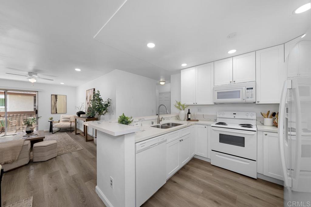 6131 Rancho Mission Road, Unit 211 San Diego, CA 92108 - Photo 11 of 21 a kitchen with a sink stove cabinets and wooden floor