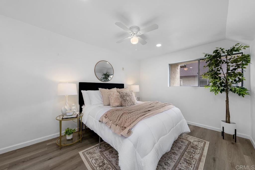 6131 Rancho Mission Road, Unit 211 San Diego, CA 92108 - Photo 13 of 21 a bedroom with a bed and a potted plant