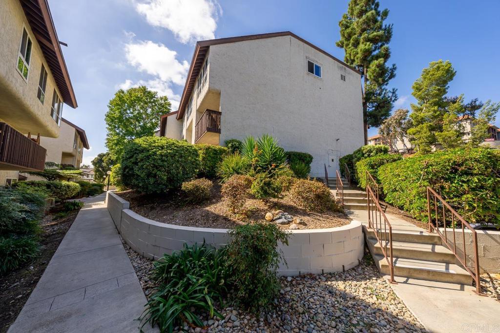 6131 Rancho Mission Road, Unit 211 San Diego, CA 92108 - Photo 18 of 21 a view of a house with a garden and plants