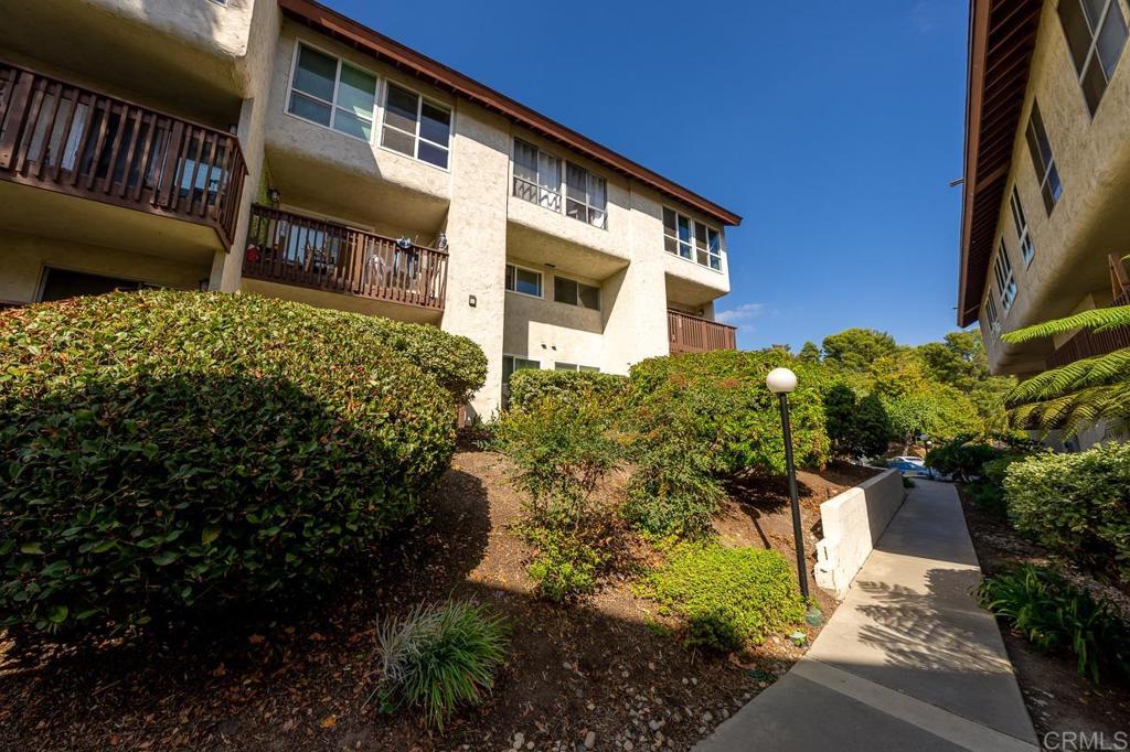 6131 Rancho Mission Road, Unit 211 San Diego, CA 92108 - Photo 19 of 21 a front view of a house with a yard