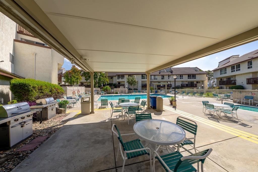 6131 Rancho Mission Road, Unit 211 San Diego, CA 92108 - Photo 20 of 21 a living room with patio a couch and chairs