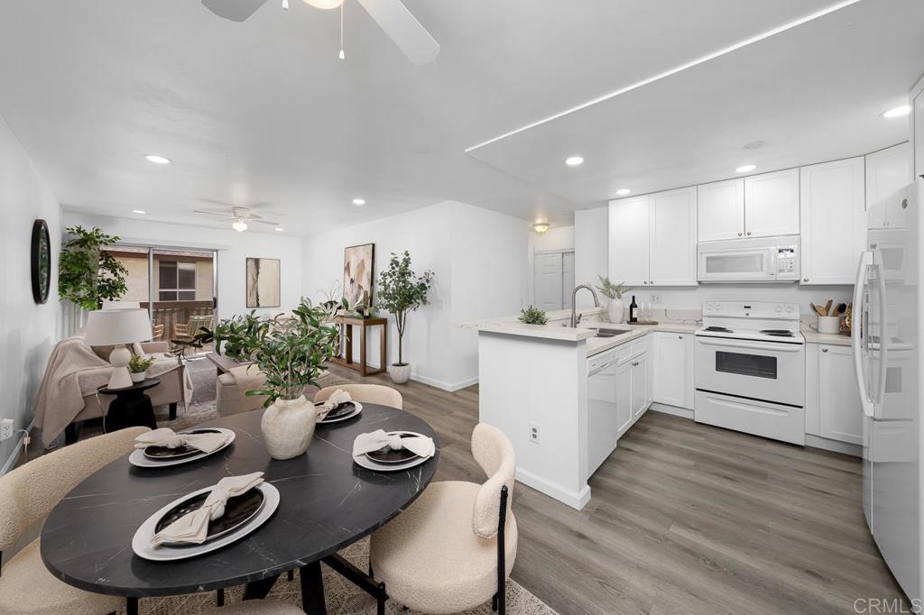 6131 Rancho Mission Road, Unit 211 San Diego, CA 92108 - Photo 2 of 21 a kitchen that has a table and chairs in it
