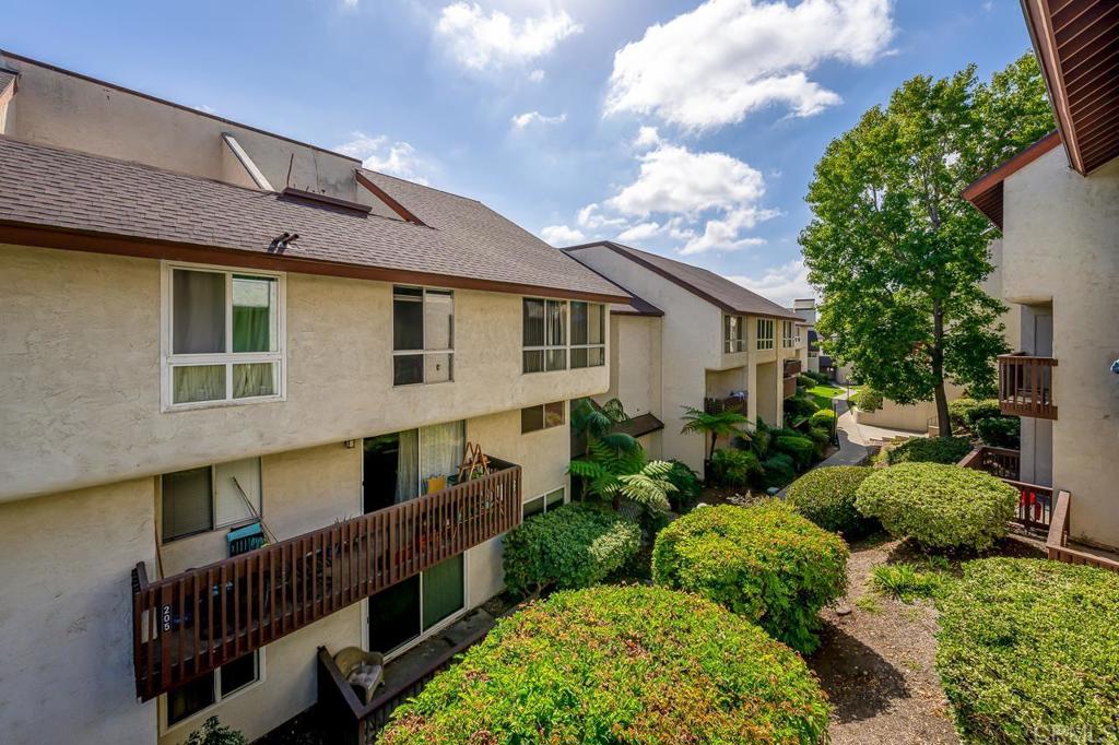 6131 Rancho Mission Road, Unit 211 San Diego, CA 92108 - Photo 3 of 21 a front view of house with yard outdoor seating and barbeque oven