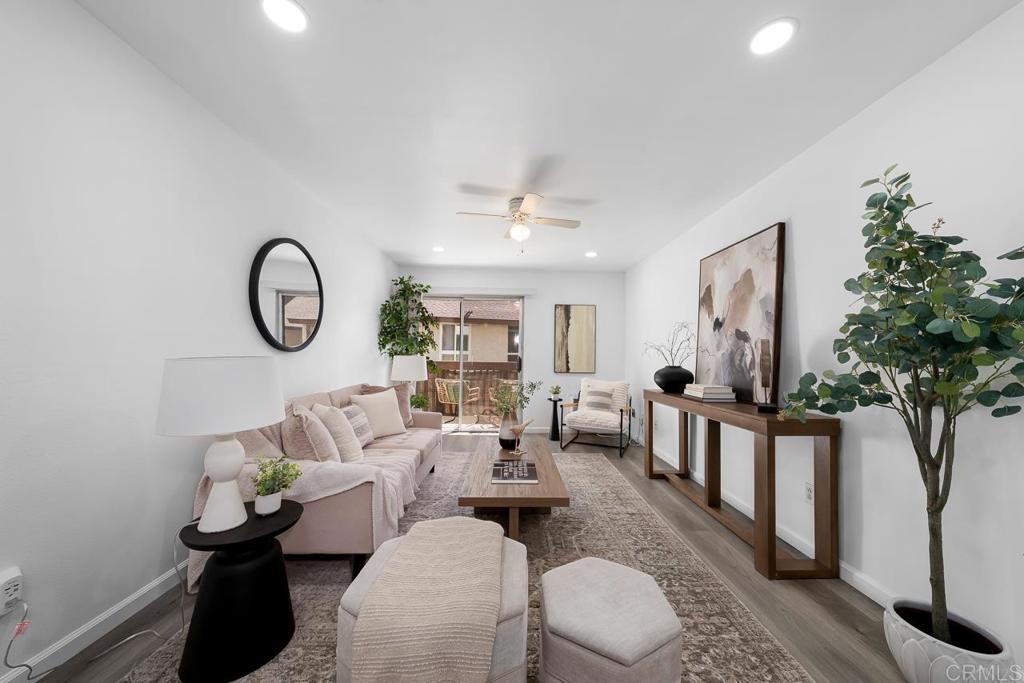 6131 Rancho Mission Road, Unit 211 San Diego, CA 92108 - Photo 6 of 21 a living room with furniture a chandelier and a fireplace