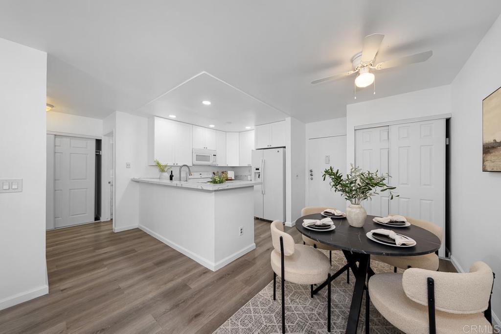 6131 Rancho Mission Road, Unit 211 San Diego, CA 92108 - Photo 8 of 21 a kitchen with a table and chairs in it