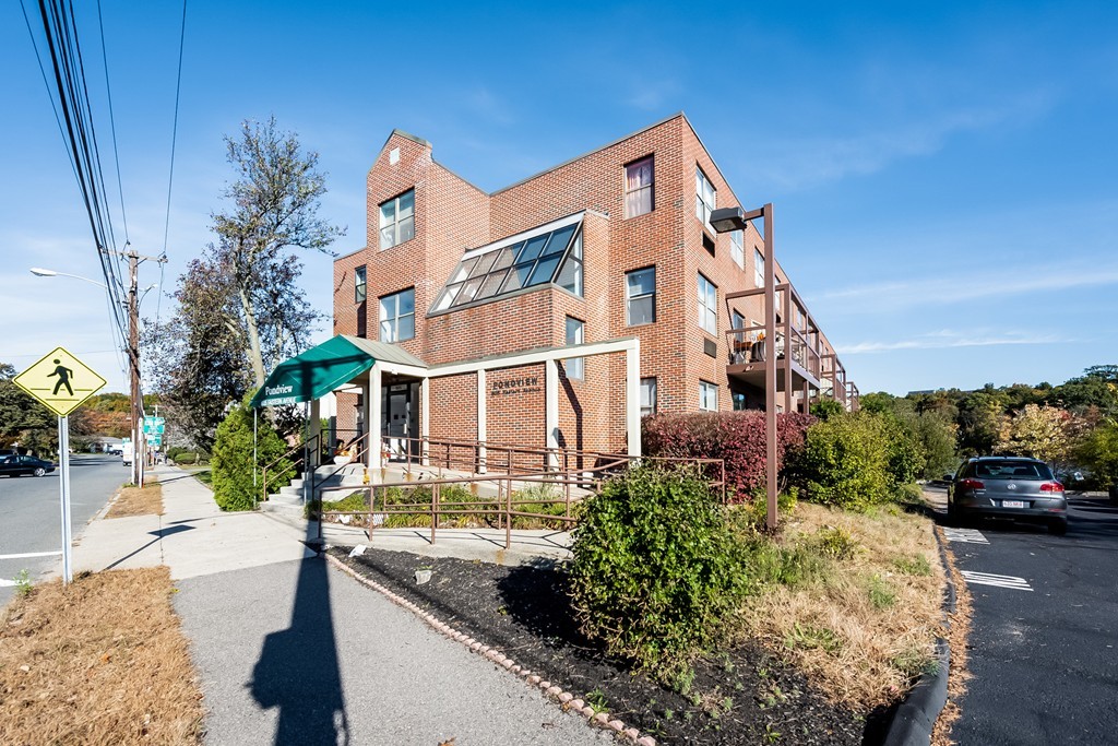 605 Eastern Avenue, Unit 211 Lynn, MA 01902 - Photo 2 of 3 a front view of a house with a garden