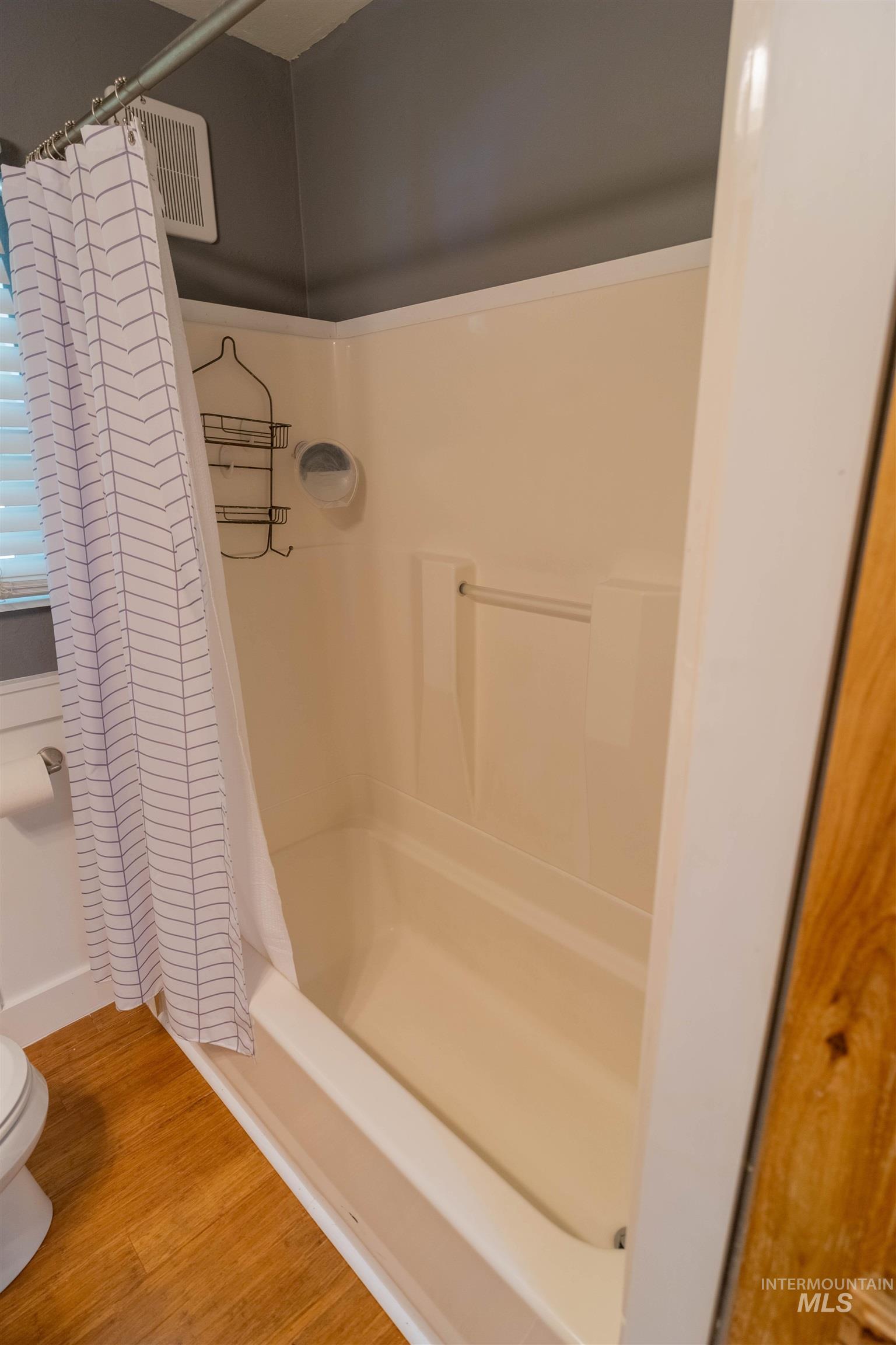 1212 14th Street Lewiston, ID 83501 - Photo 15 of 50 Bathroom featuring wood finished floors and shower / bathtub combination with curtain