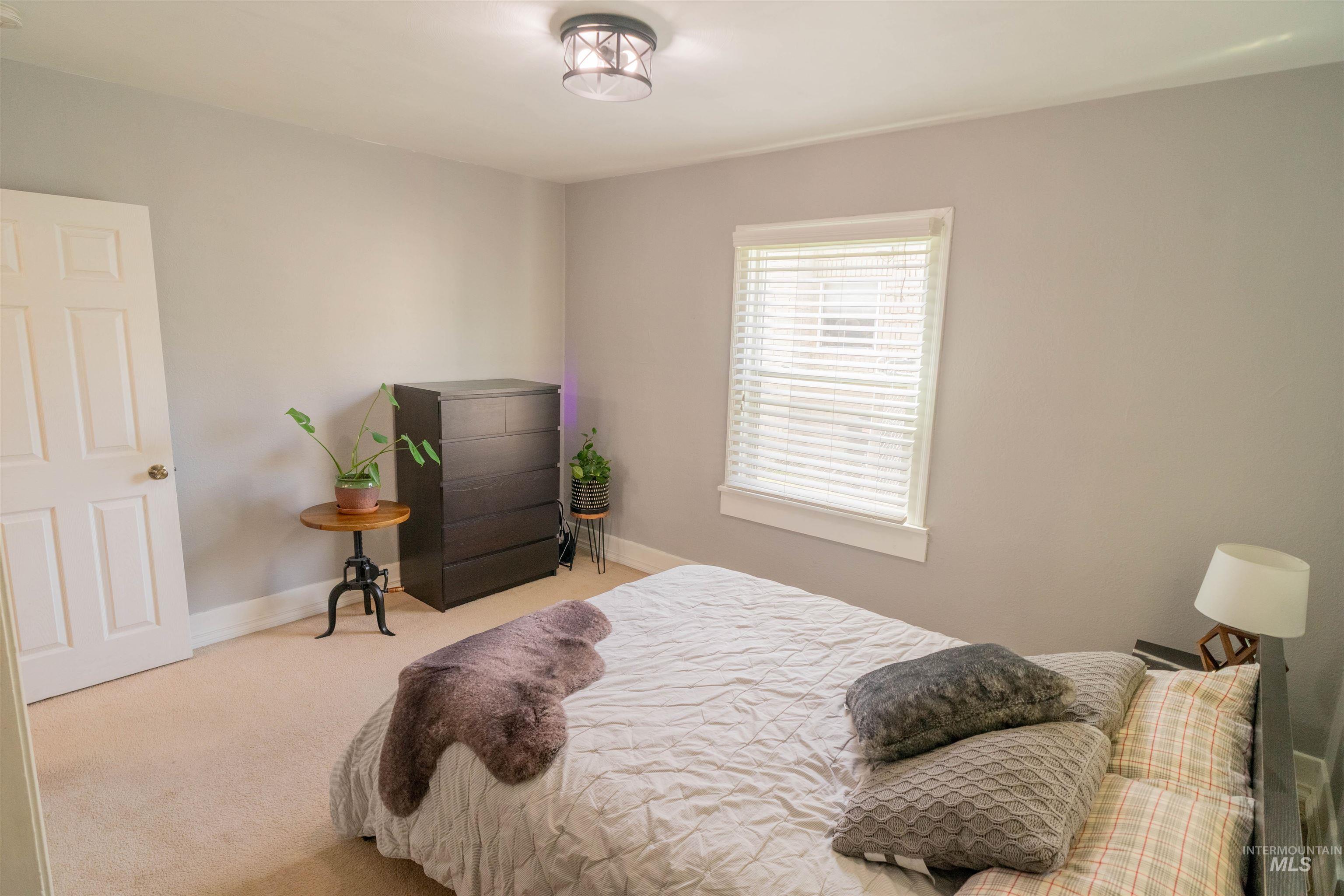 1212 14th Street Lewiston, ID 83501 - Photo 18 of 50 Bedroom with light carpet and baseboards