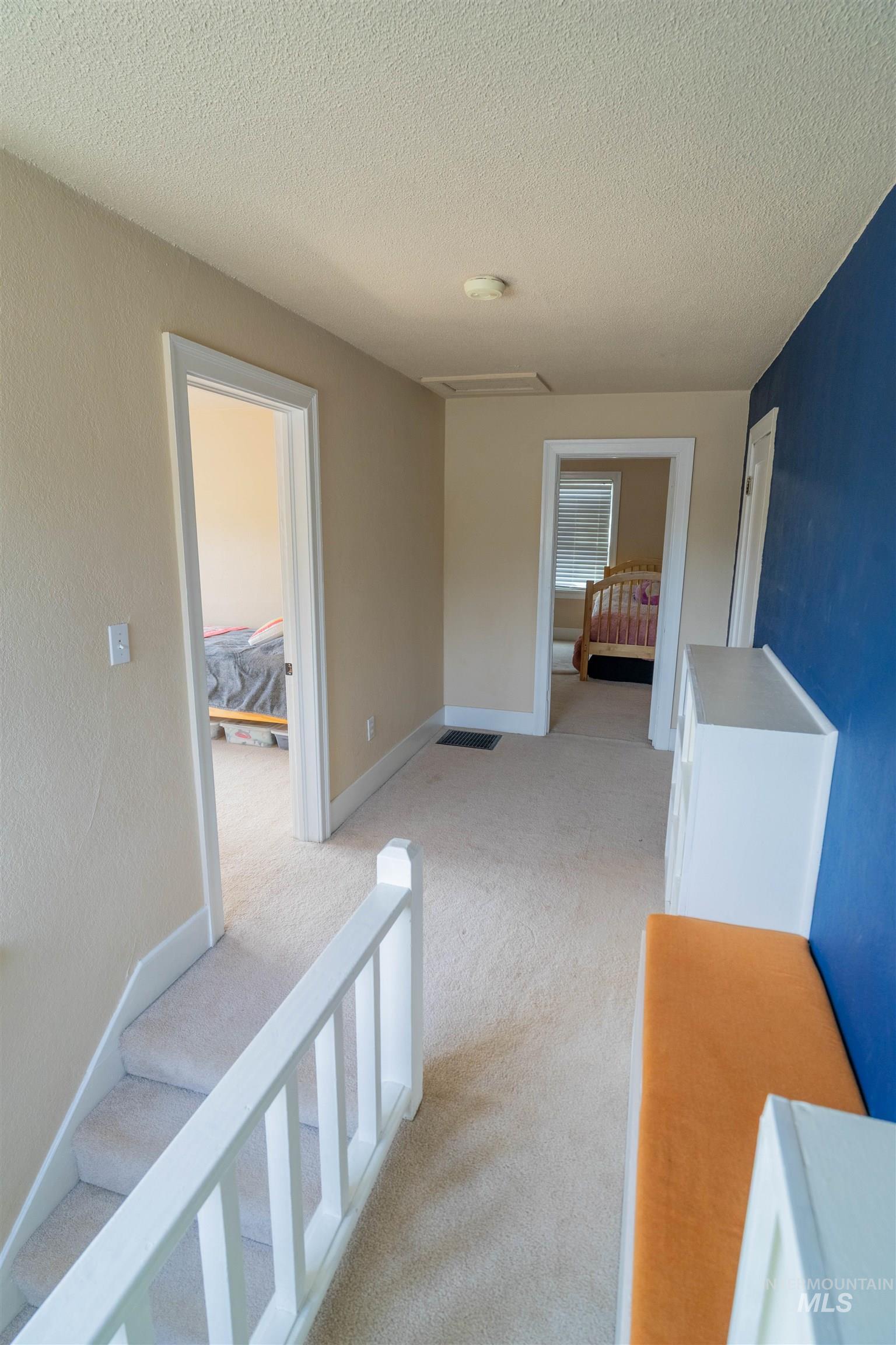 1212 14th Street Lewiston, ID 83501 - Photo 19 of 50 Corridor featuring light colored carpet and a textured ceiling