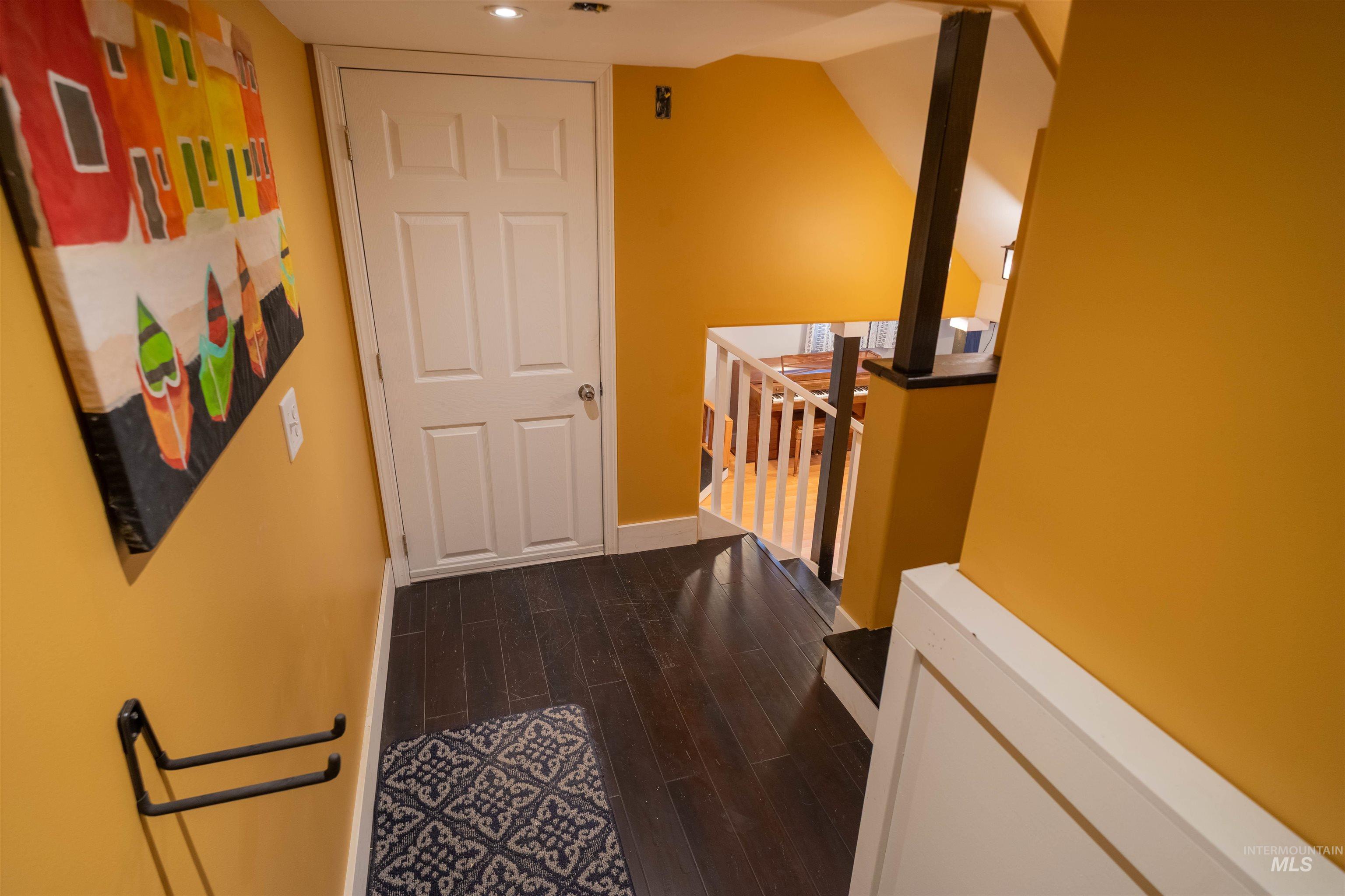 1212 14th Street Lewiston, ID 83501 - Photo 28 of 50 Hallway with dark wood-style floors and an upstairs landing