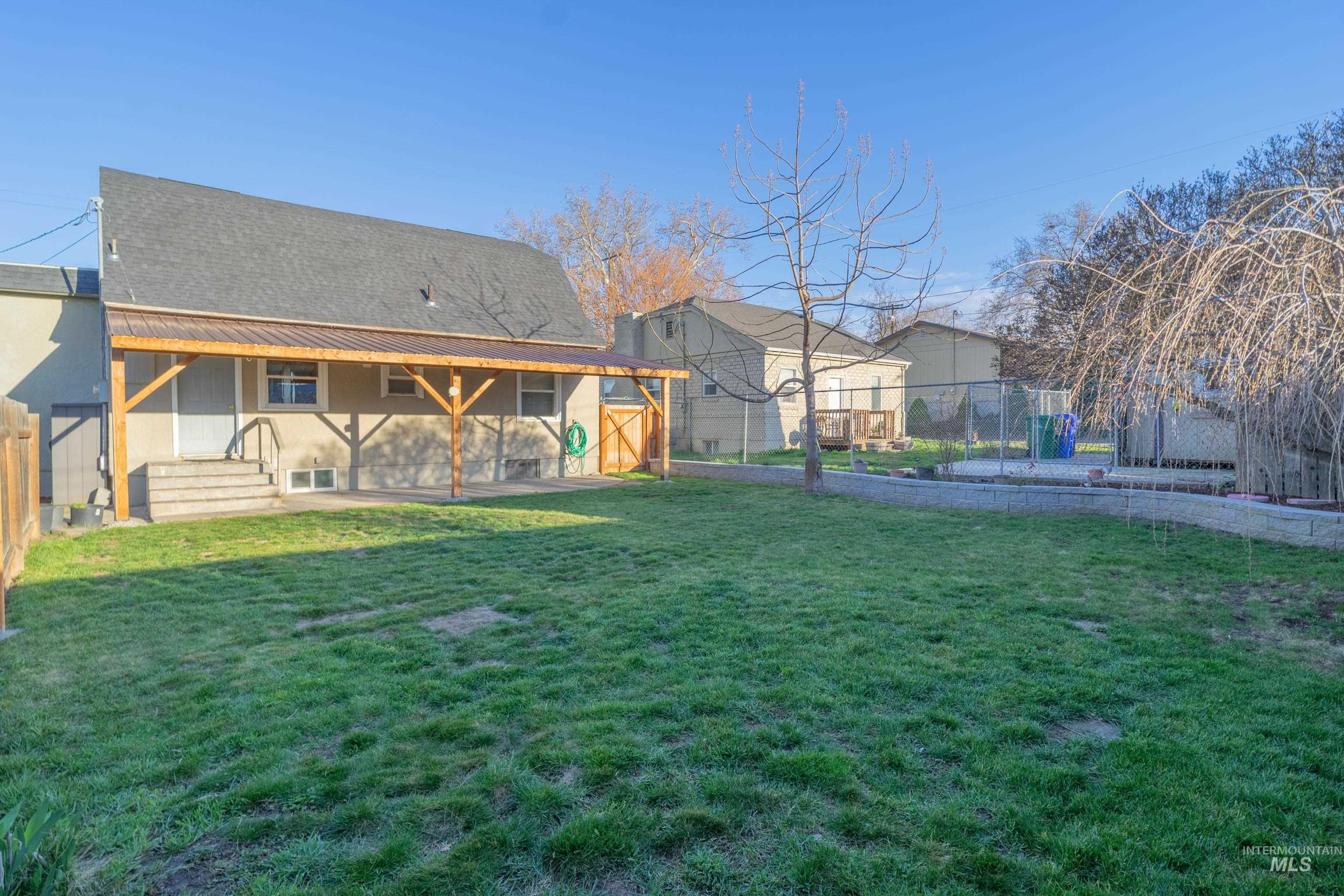1212 14th Street Lewiston, ID 83501 - Photo 38 of 50 Rear view of property with a patio, stucco siding, and roof with shingles