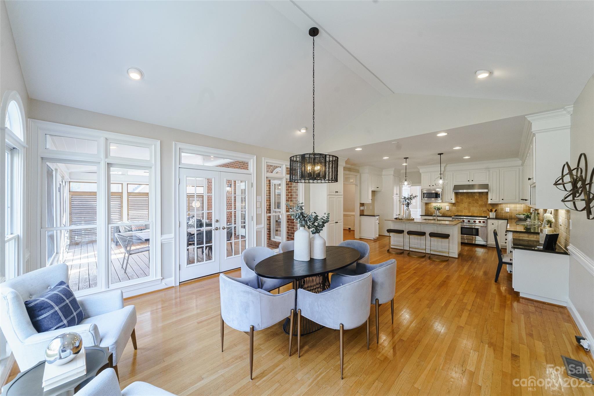 2134 Glade Hill Road Charlotte, NC 28270 - Photo 11 of 48 a dining room with furniture wooden floor a chandelier and a rug