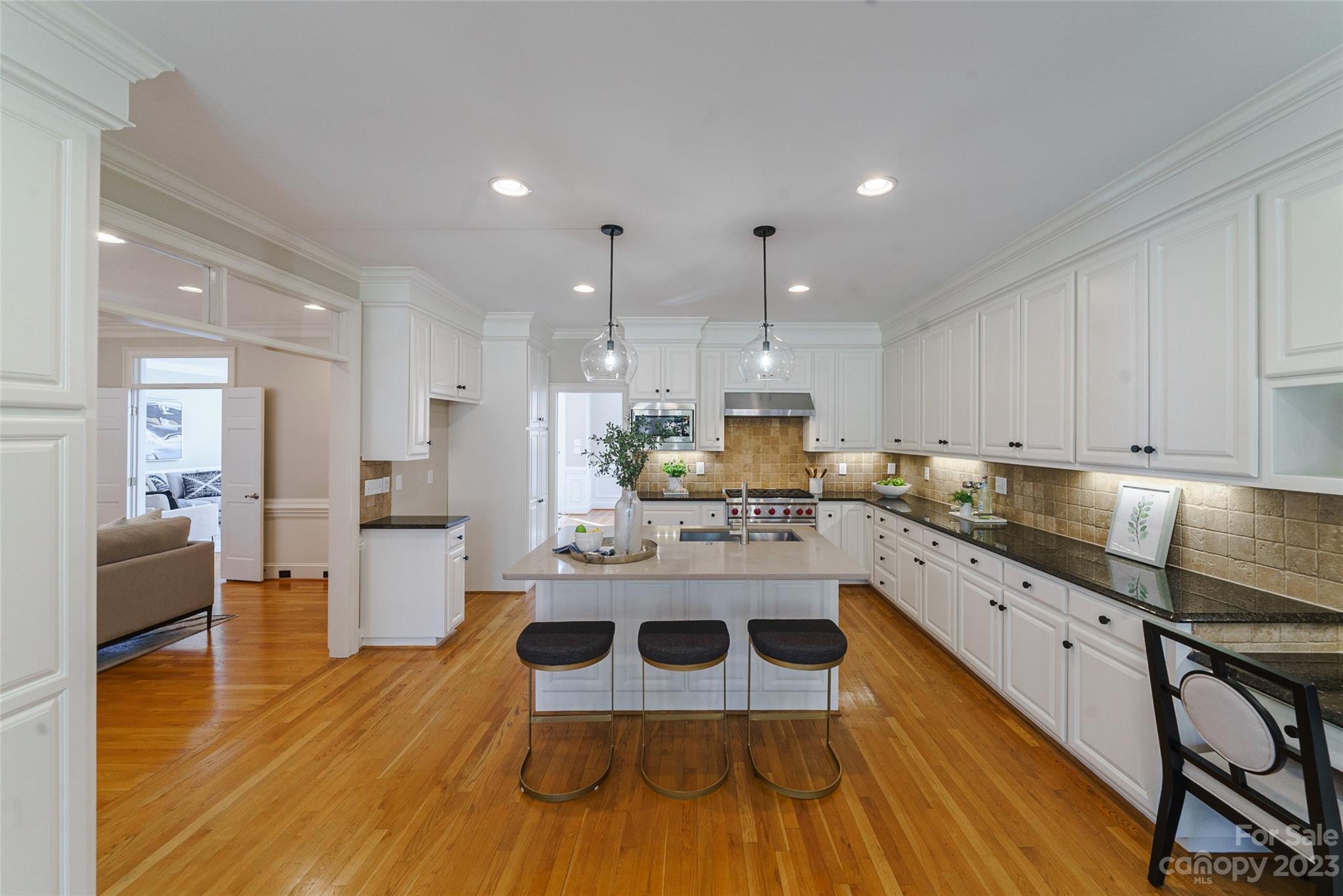 2134 Glade Hill Road Charlotte, NC 28270 - Photo 14 of 48 a large kitchen with cabinets wooden floor and stainless steel appliances
