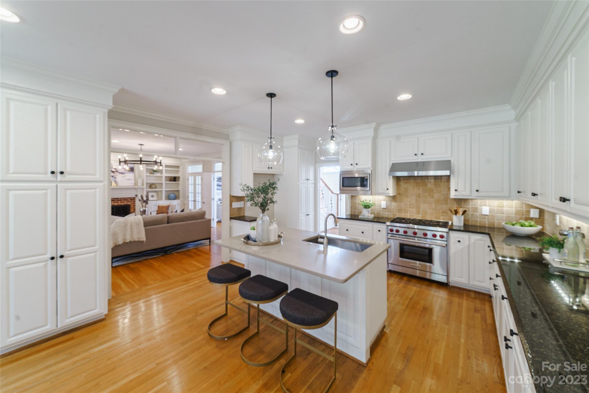 2134 Glade Hill Road Charlotte, NC 28270 - Photo 15 of 48 a kitchen with a refrigerator a stove top oven a sink dishwasher and white cabinets with wooden floor