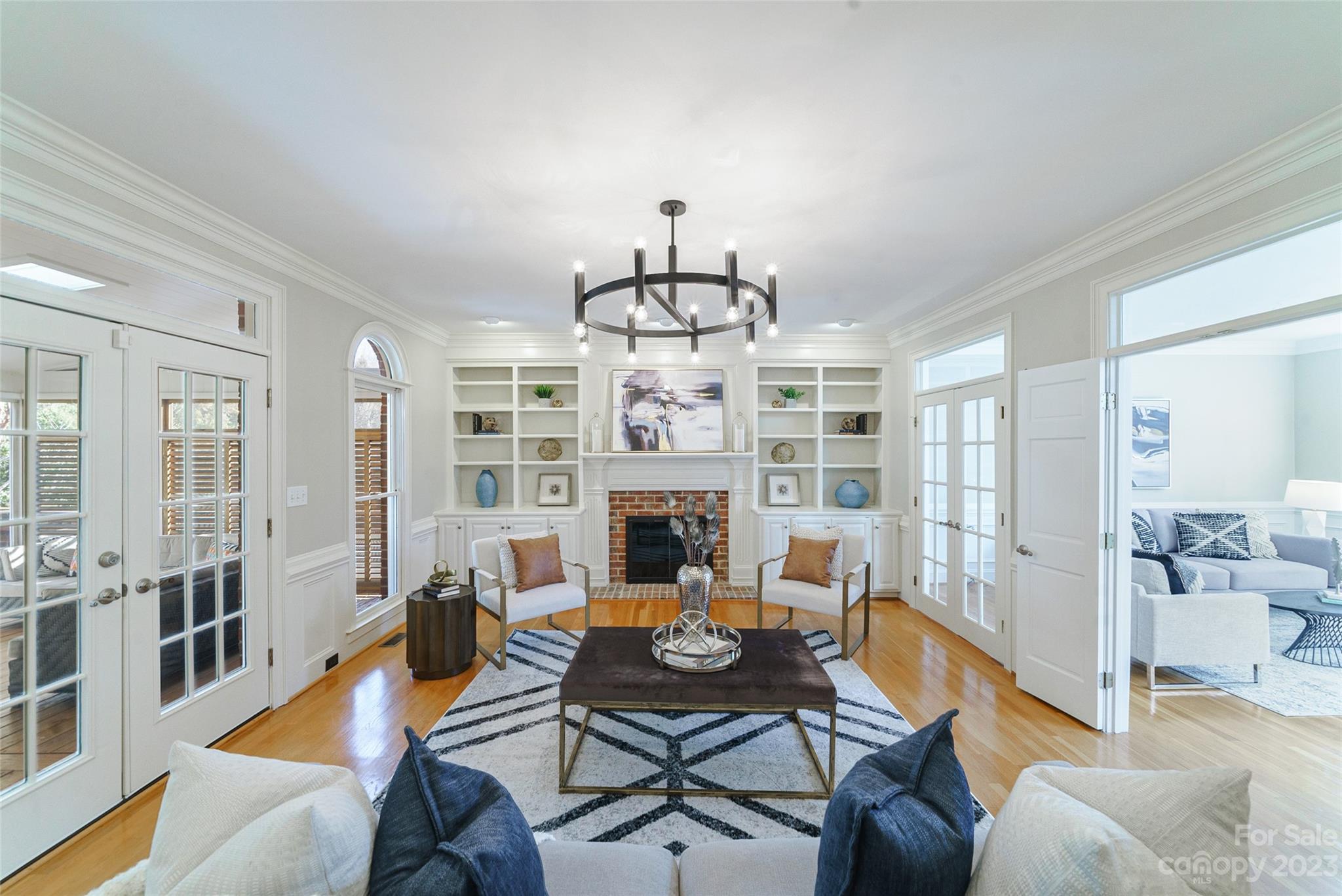 2134 Glade Hill Road Charlotte, NC 28270 - Photo 16 of 48 a living room with furniture a fireplace and a chandelier
