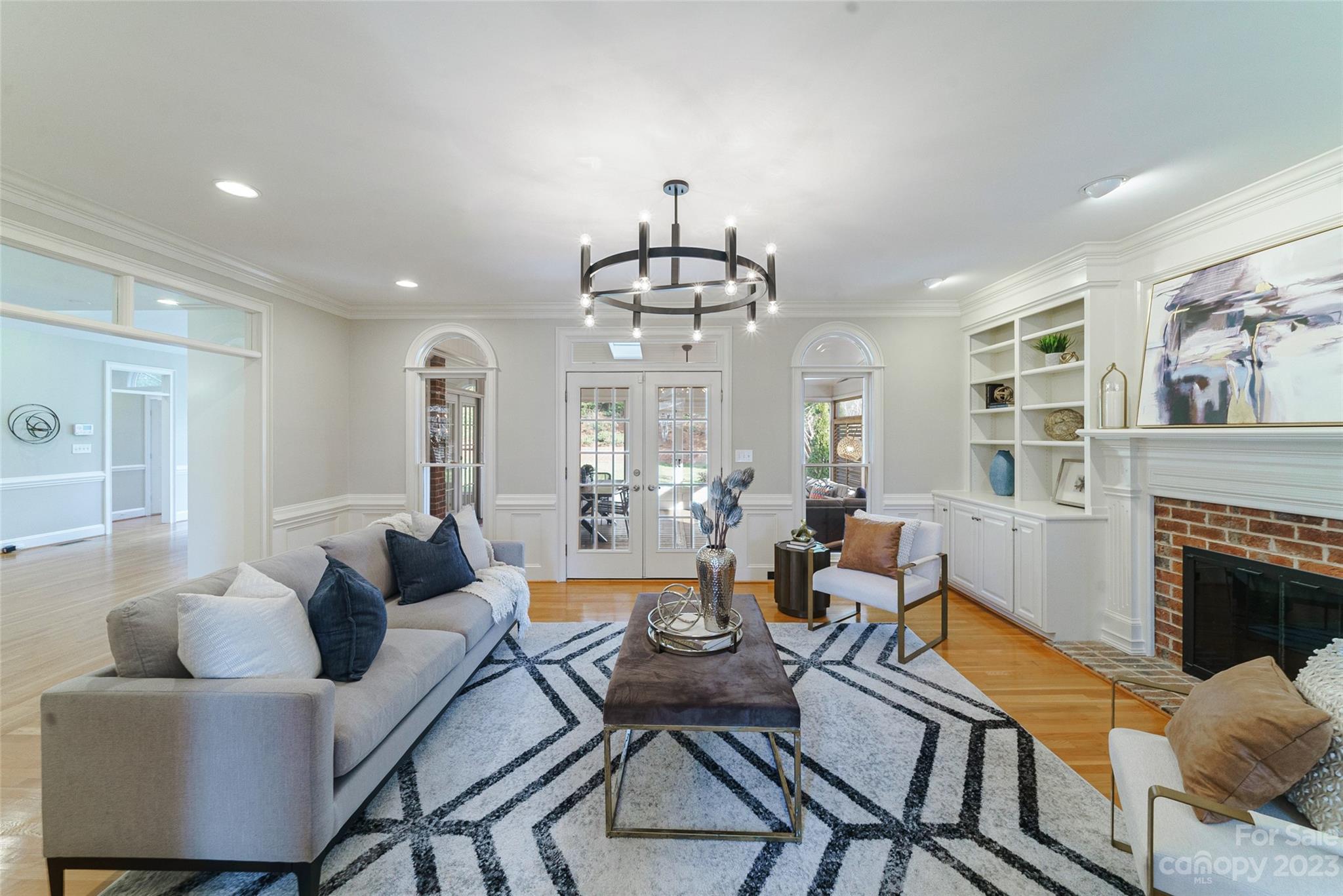 2134 Glade Hill Road Charlotte, NC 28270 - Photo 17 of 48 a living room with fireplace furniture and a chandelier
