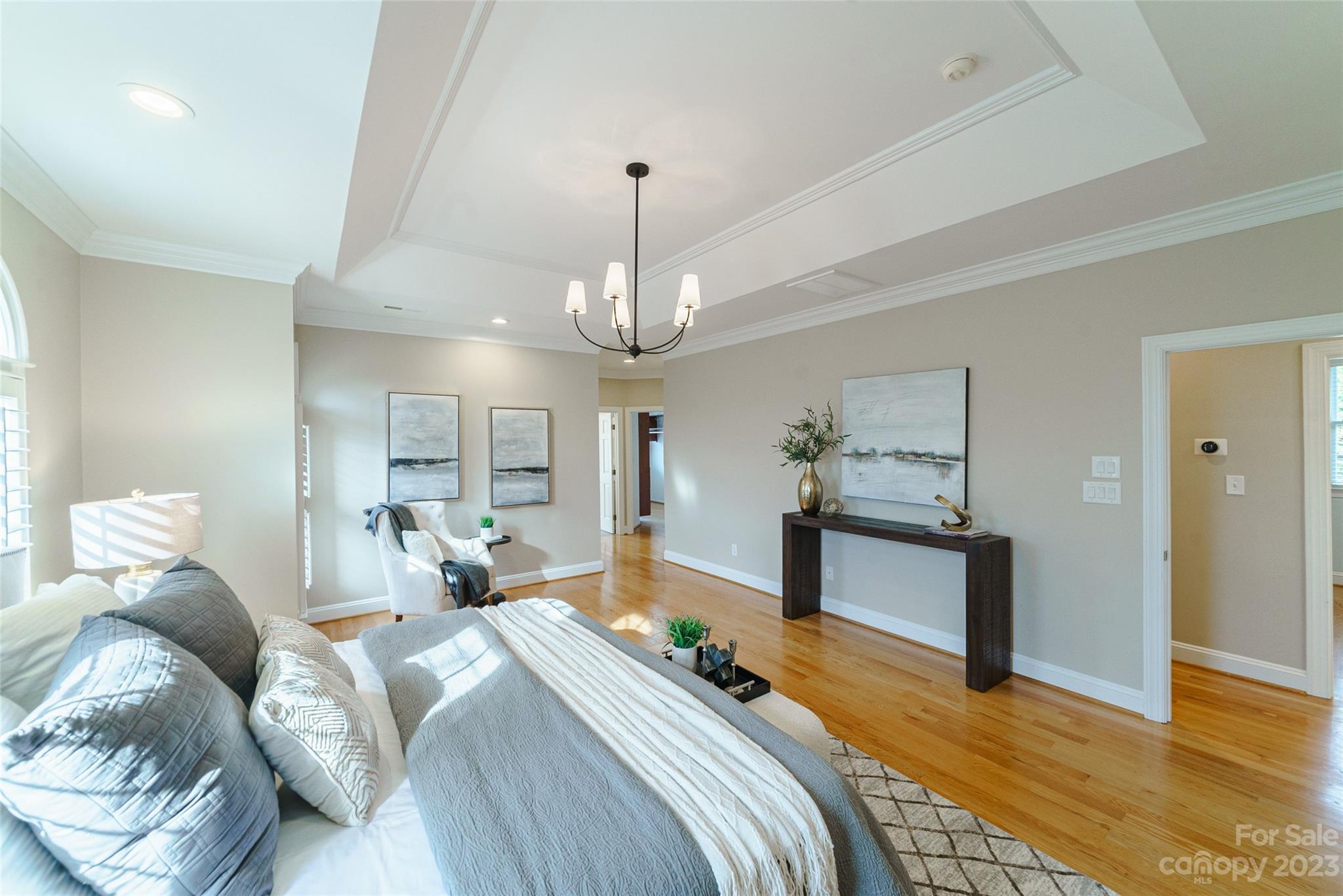 2134 Glade Hill Road Charlotte, NC 28270 - Photo 22 of 48 a bedroom with a bed and a chandelier