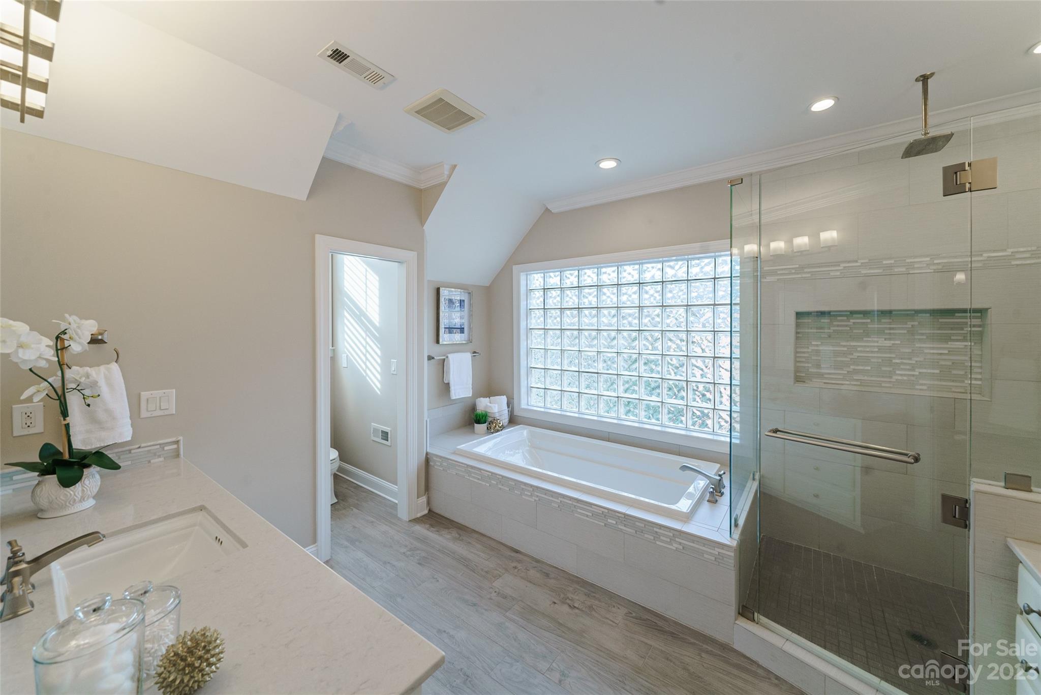 2134 Glade Hill Road Charlotte, NC 28270 - Photo 24 of 48 a bathroom with a tub a sink and a large window
