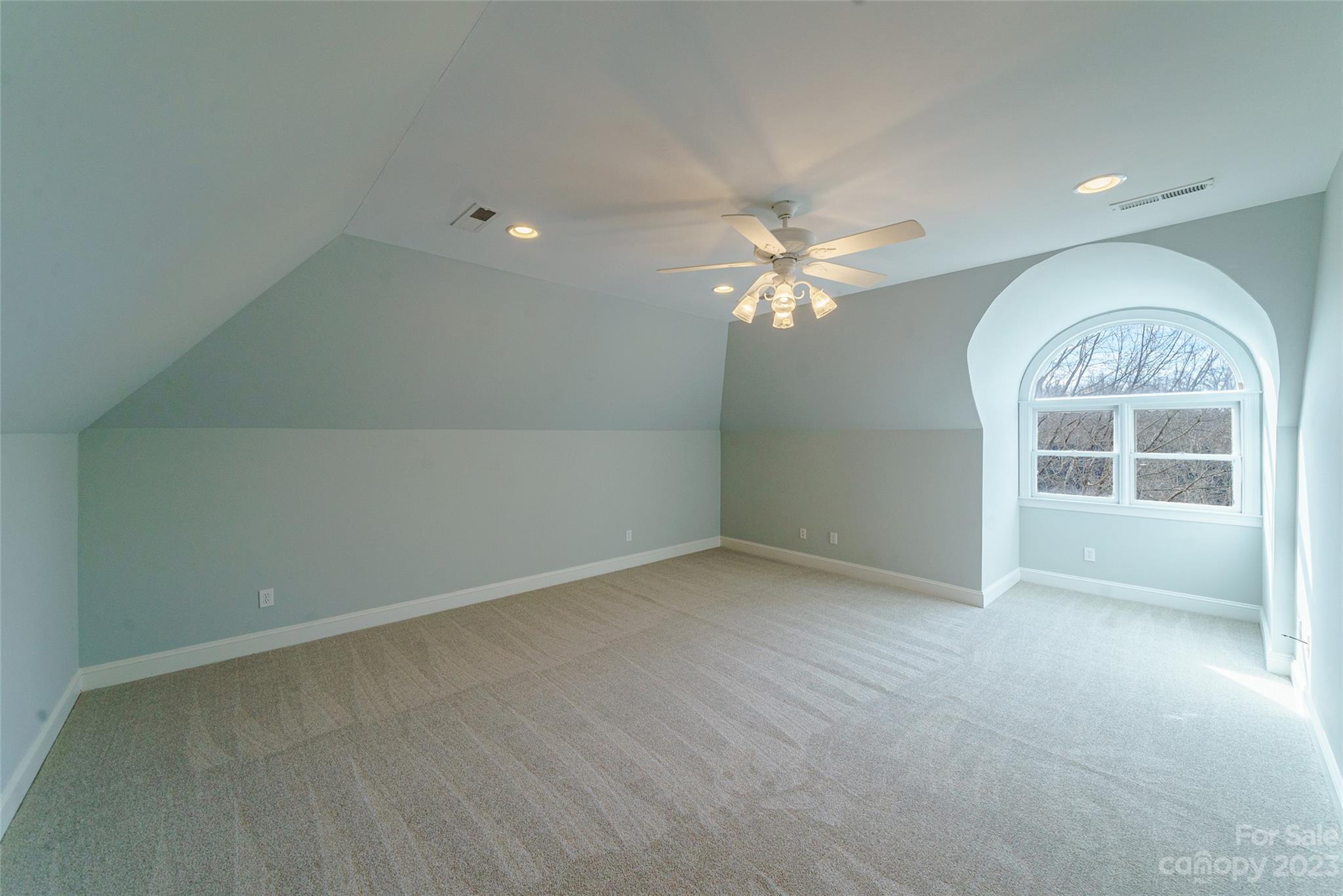 2134 Glade Hill Road Charlotte, NC 28270 - Photo 38 of 48 an empty room with chandelier fan and windows