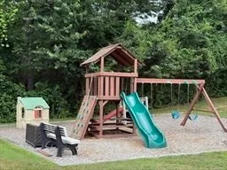 a view of playground with a slide and swing