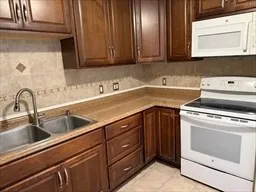 a kitchen with a sink cabinets and stainless steel appliances
