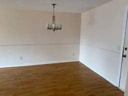 a view of a room with wooden floor and white doors